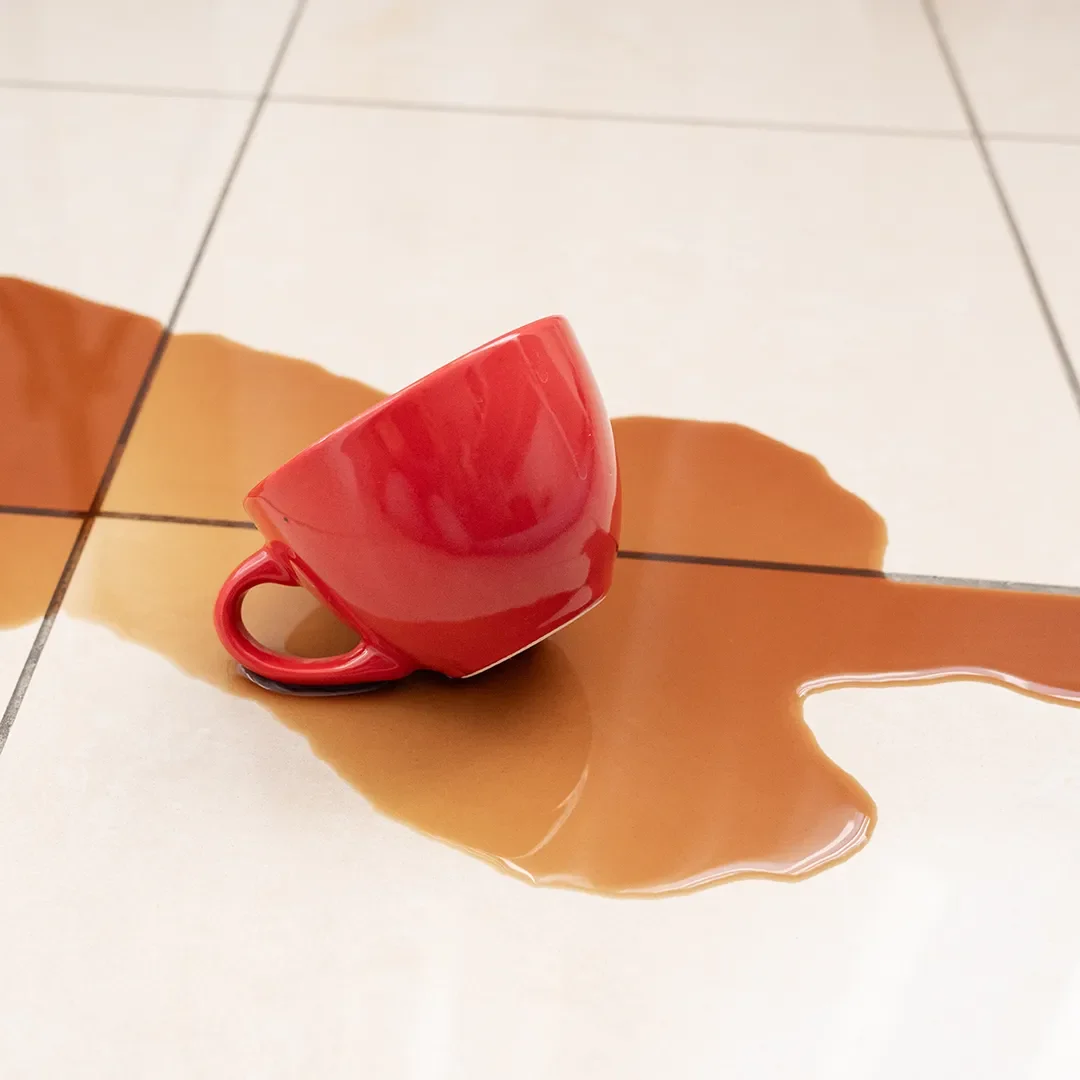 Cup of coffee spilled on tile floors